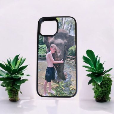 A phone case featuring a man affectionately interacting with an elephant.