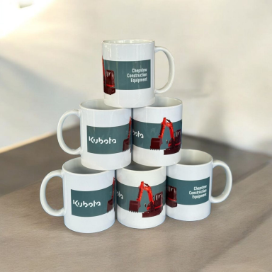 A stack of six white mugs featuring construction machinery designs.